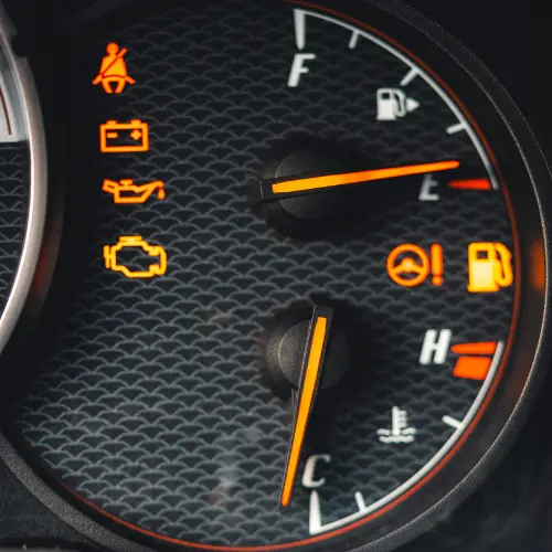 Vehicle dashboard showing service icons and illuminated warning lights